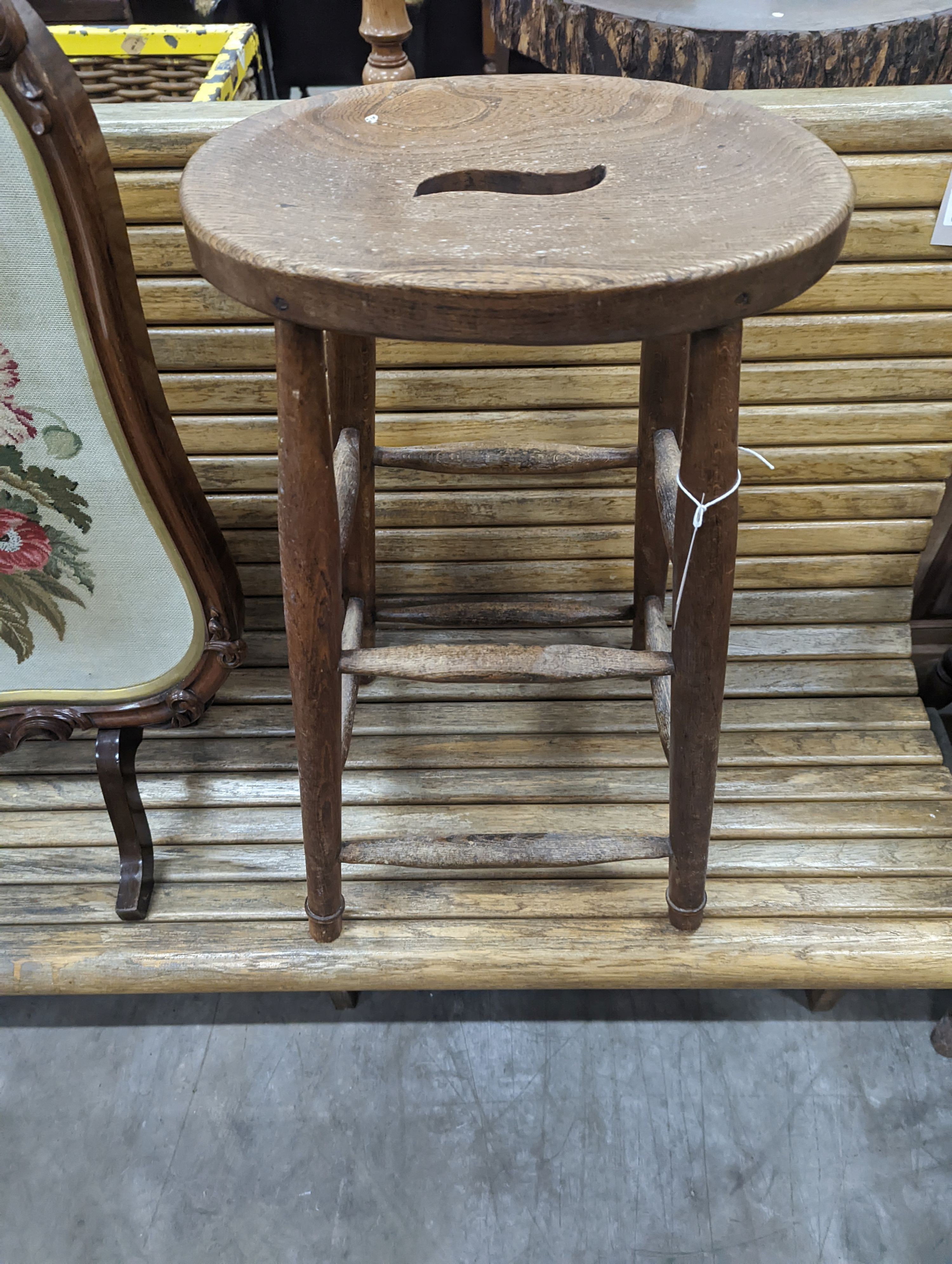 An elm and beech stool together with a Victorian rosewood tapestry firescreen